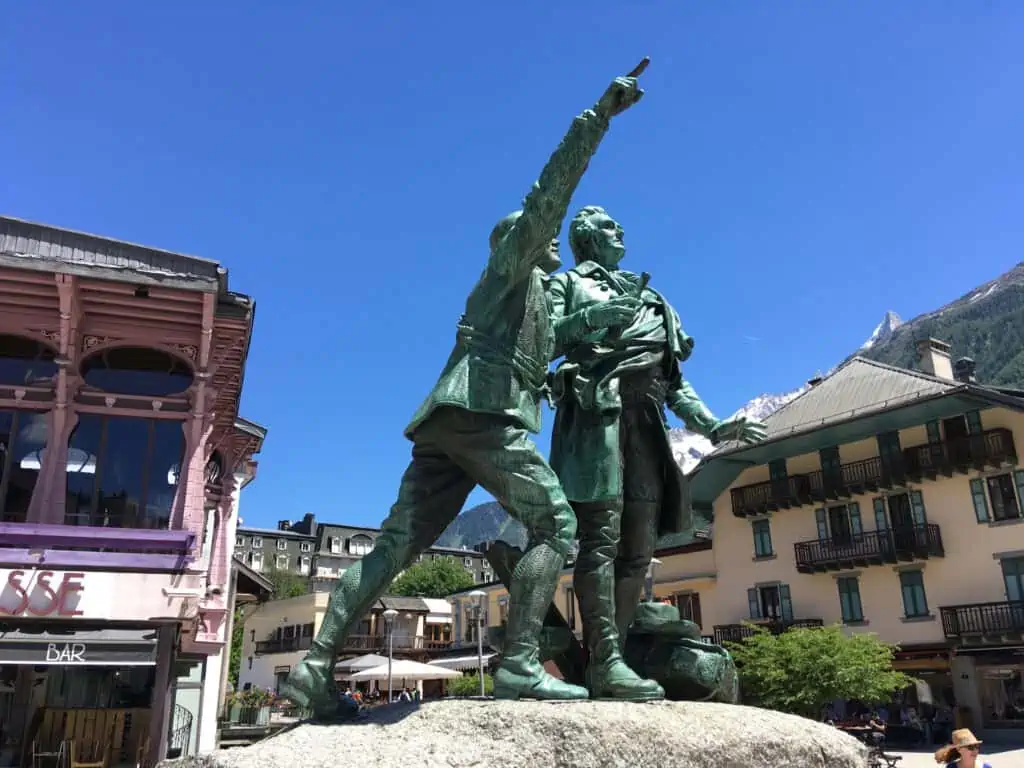 The famous statue is situated in downtown Chamonix France that points toward Mont Blanc.