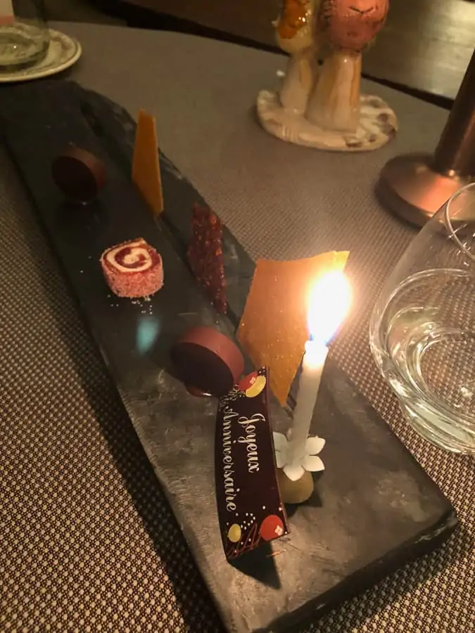 Photo of dessert tray with candle for our anniversary at Chateau De Pray