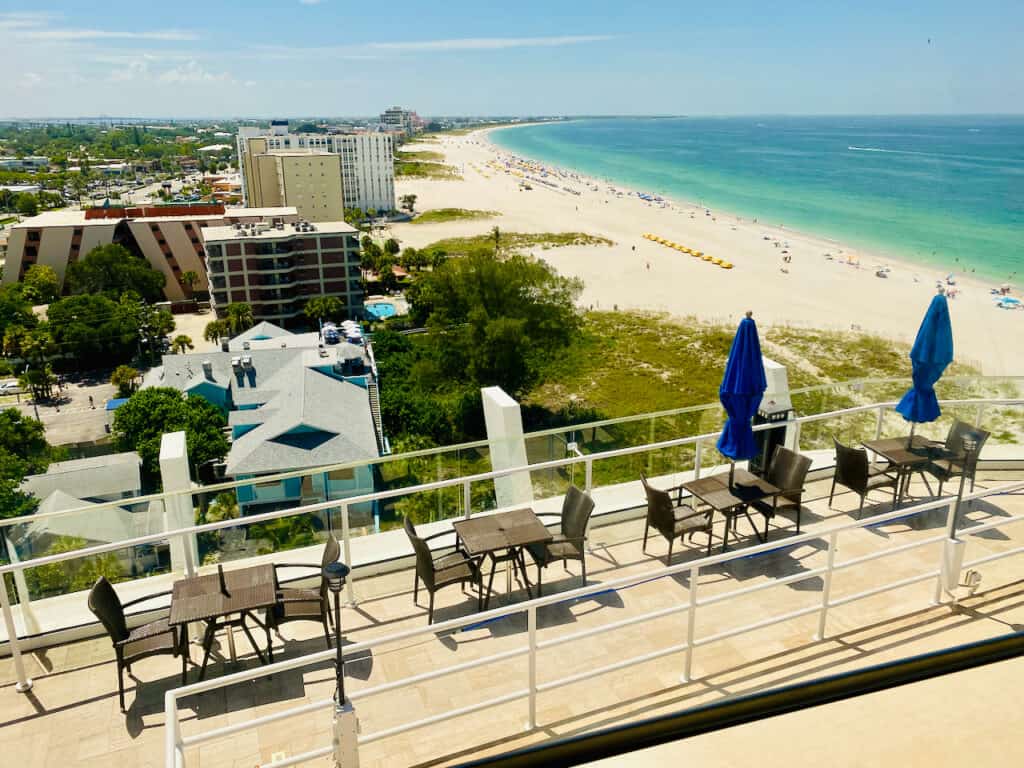 Spectacular views from Level 11 Rooftop Bar & Lounge.  Photo shows outdoor seating and tables with Gulf of Mexi o views. level 11 rooftop bar photos