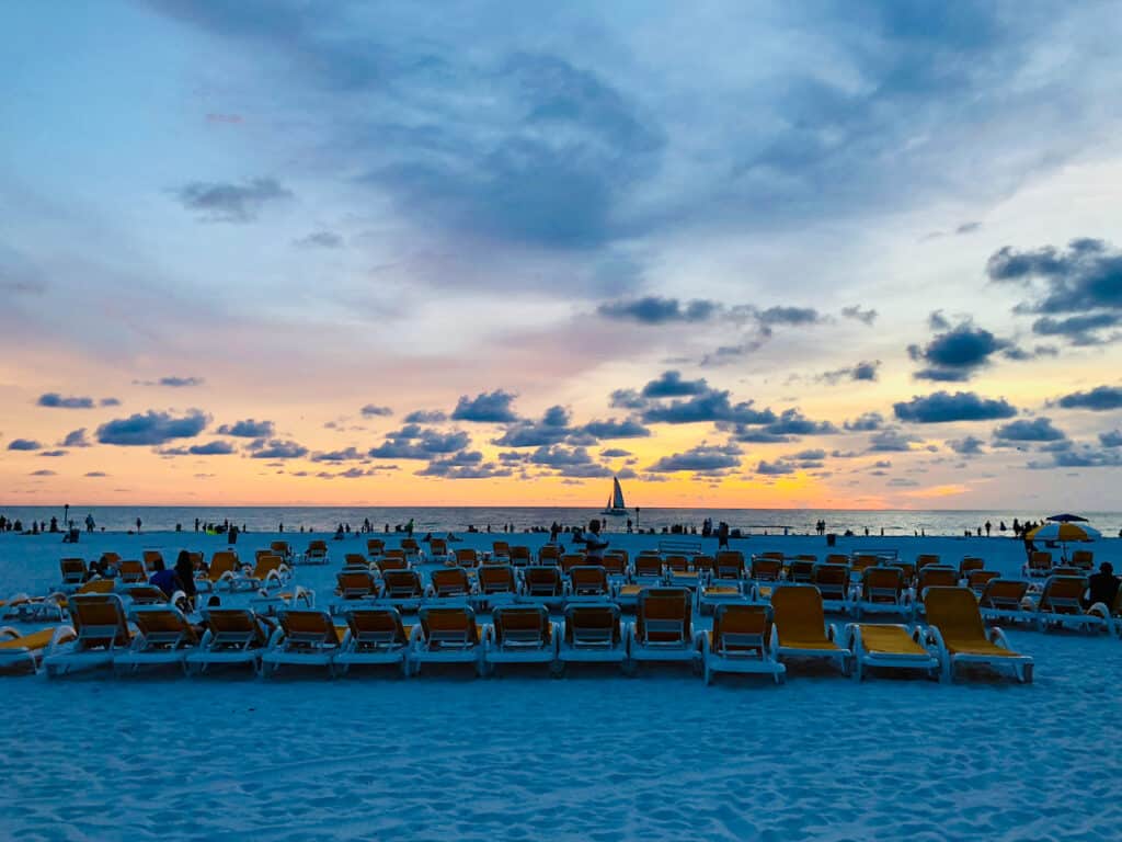 Things to do in Tampa for couples - see a sunset at Clearwater Beach with sailboats