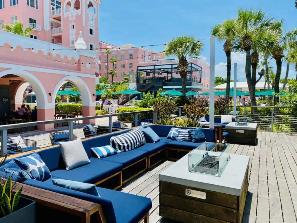 The pink palace otherwise known as The Don CeSar has been lounge chairs and seating near the pool area with fire pits.  The photo shows the expanding outdoor area with many things to do at this St Pete Spring Break Hotel.