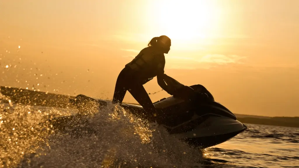Jet Ski Indian Rocks Beach at sunset with gorgeous yellow orange ski in the background.  By YanLev Canva.  