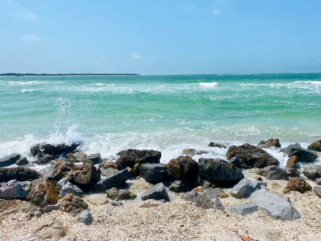 Pass-a-Grille beach southern tip has large rocks and boulders to help with the island formation.  The Gulf of Mexico water is a turquoise green.