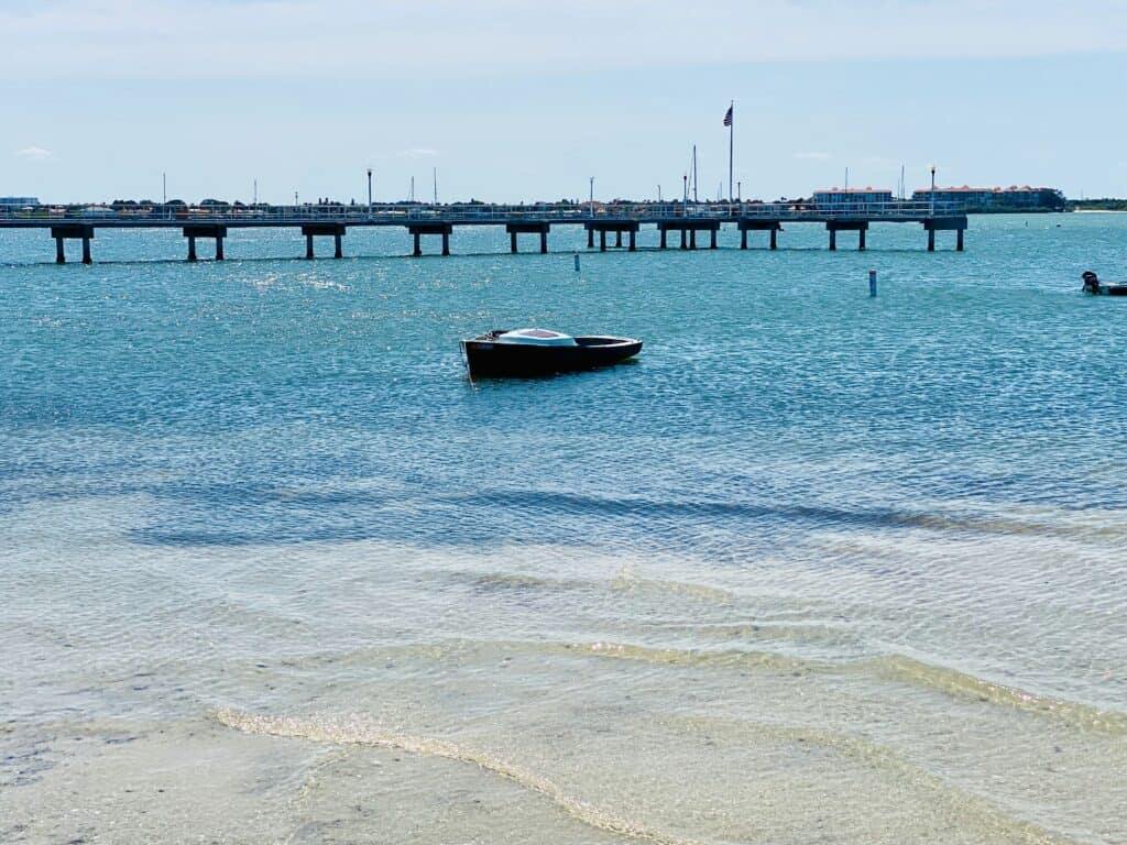 Gulfport, FL has beautiful views of Boca Ciega Bay and has free boat docks available.  Showing a boat parked next to the dock.