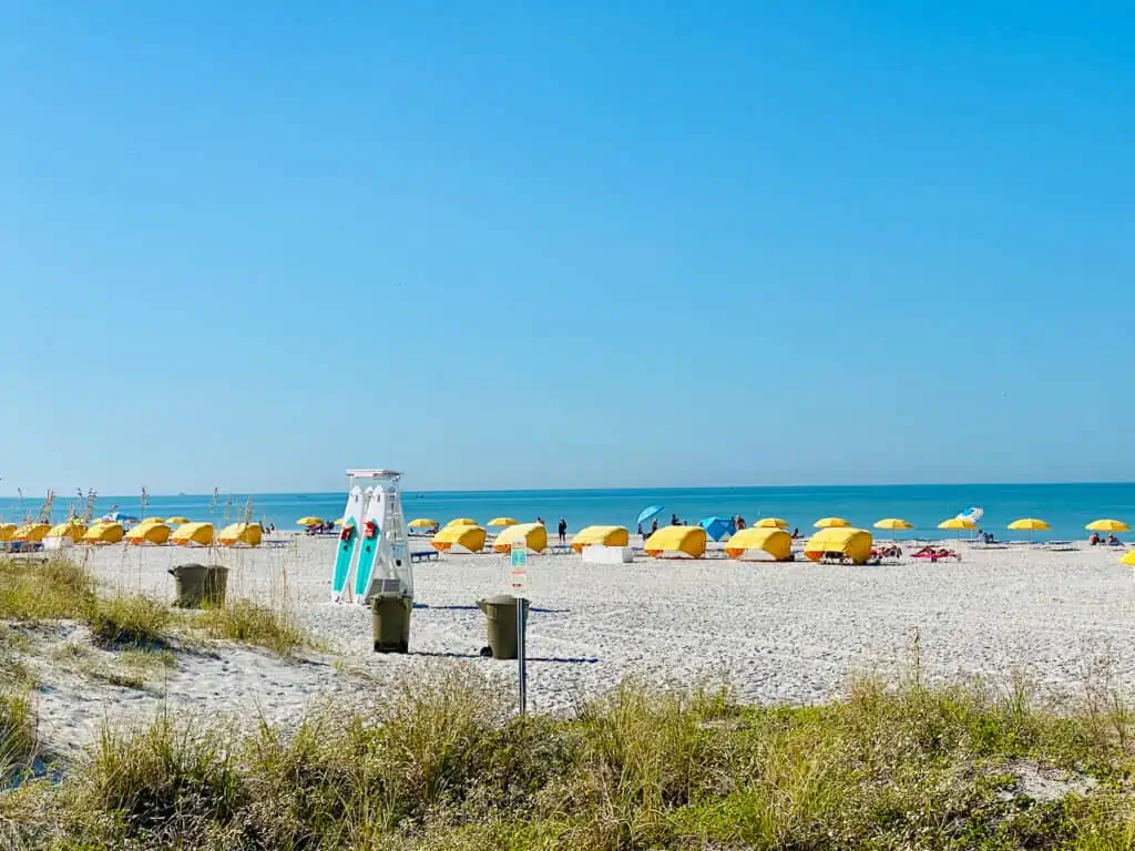 Upham Beach Park has views of paddleboards to use and yellow cabanas and chairs to rent at St. Pete Beach, FL.