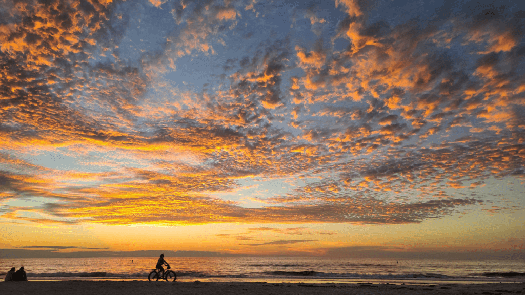 Indian Rocks Beach sunset with bicycle rider in the distance.