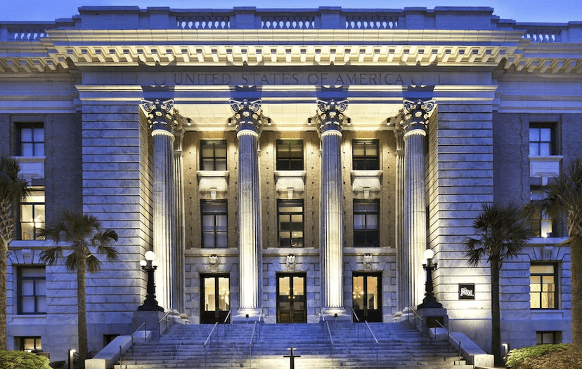 Le Méridien Tampa, a boutique hotel in tampa with beautiful roman columns and exterior at night.