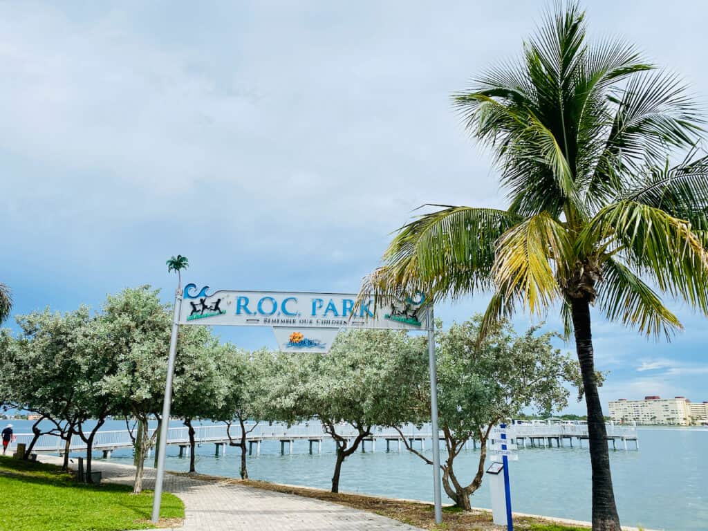 ROC Park across from Archibald Memorial Park - showing the sign and beautiful bay water views and pier. 