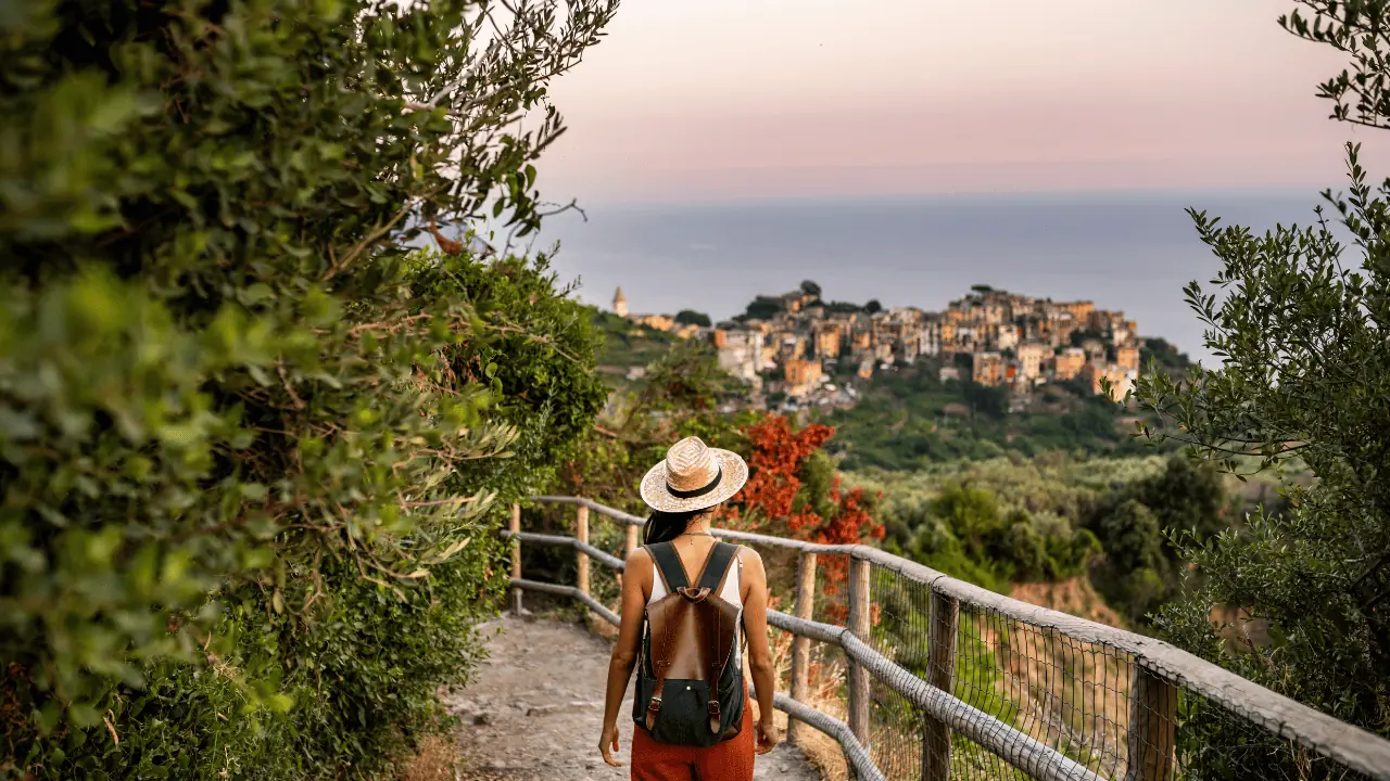 Hiking trails in the cinque terre showing a girl walking the blue trail