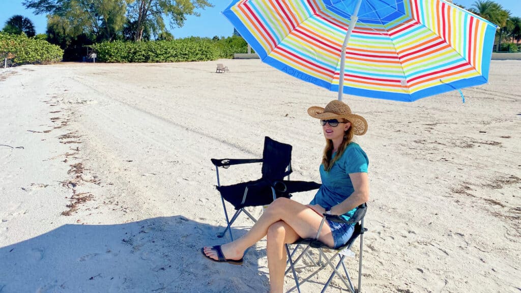 Erin at the beach trying out a outdoor chair with UV protection