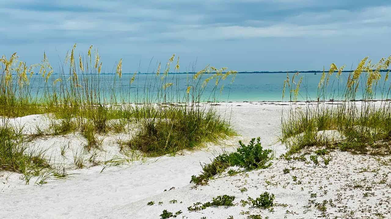 Photo of white sandy beaches, dunes, and bright blue waters of the Gulf of Mexico at Fort De Soto 