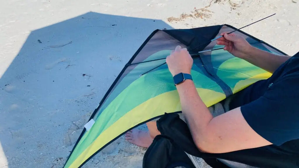 Photo of Erin's husband putting our kite together at the beach.